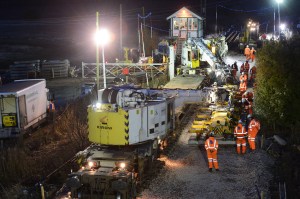 Over the weekend of the 2nd- 3rd February 2013 the junction at Sleaford North was renewed. The new switches were brought to the site per-assembled using Network Rail's new tilt wagons. Here, a pair of Kirow cranes maneuver one of the switches into place.