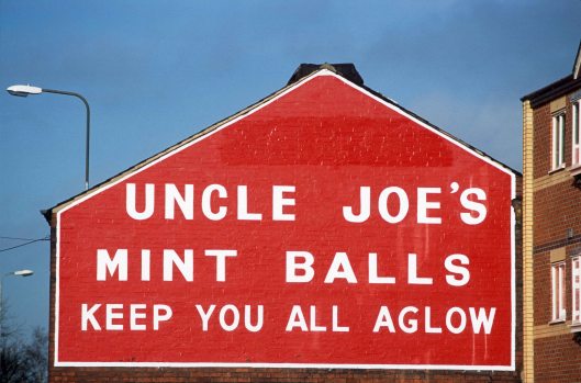 T15157.Ad for one of the town's most popular export. Uncle Joe's Mint Balls. Wigan. England. 28.11.2002crop