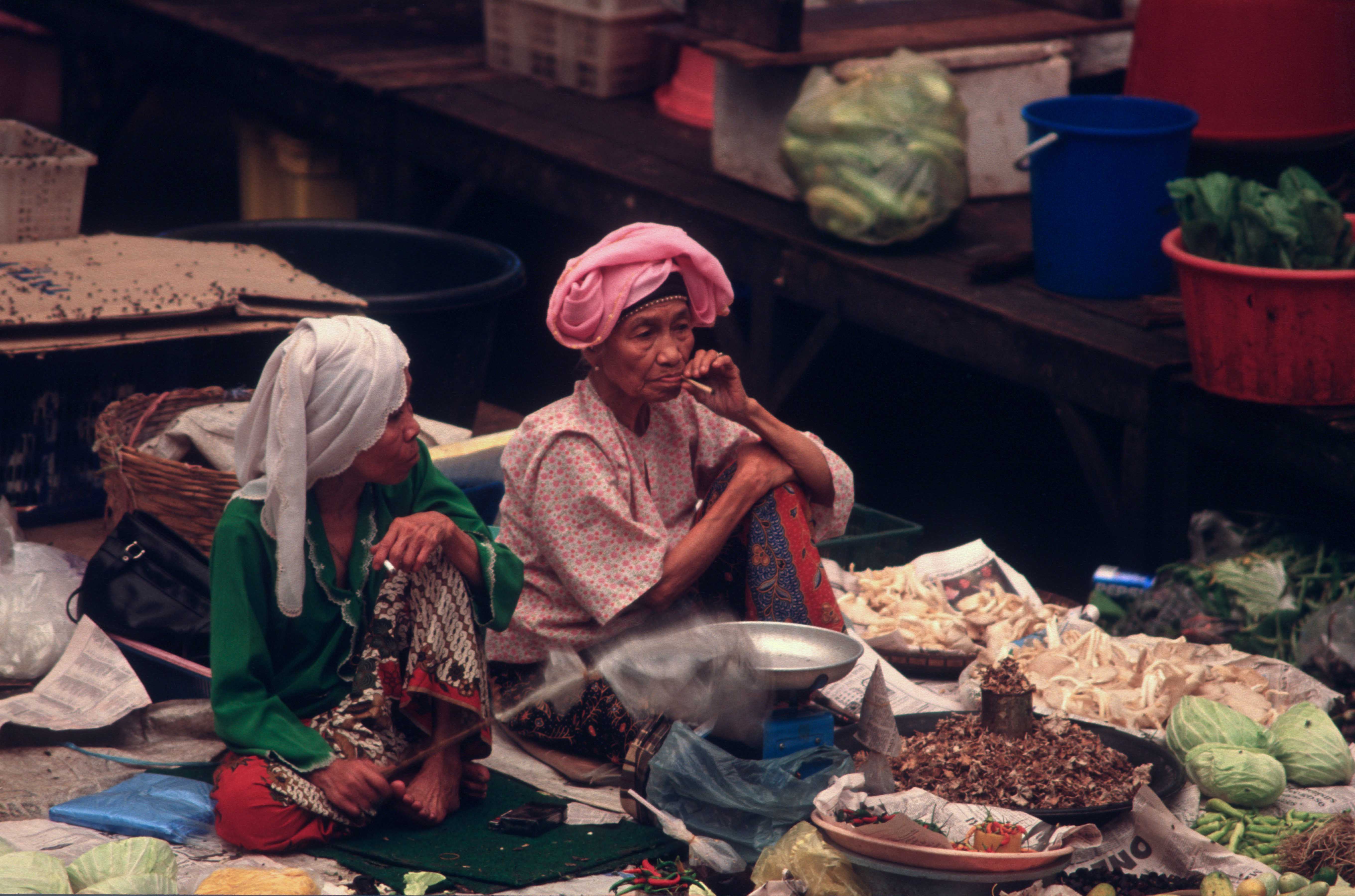 T7306. Two old women on a stall. Indoor market. Kota Baru. Malaysia. June. 1998crop