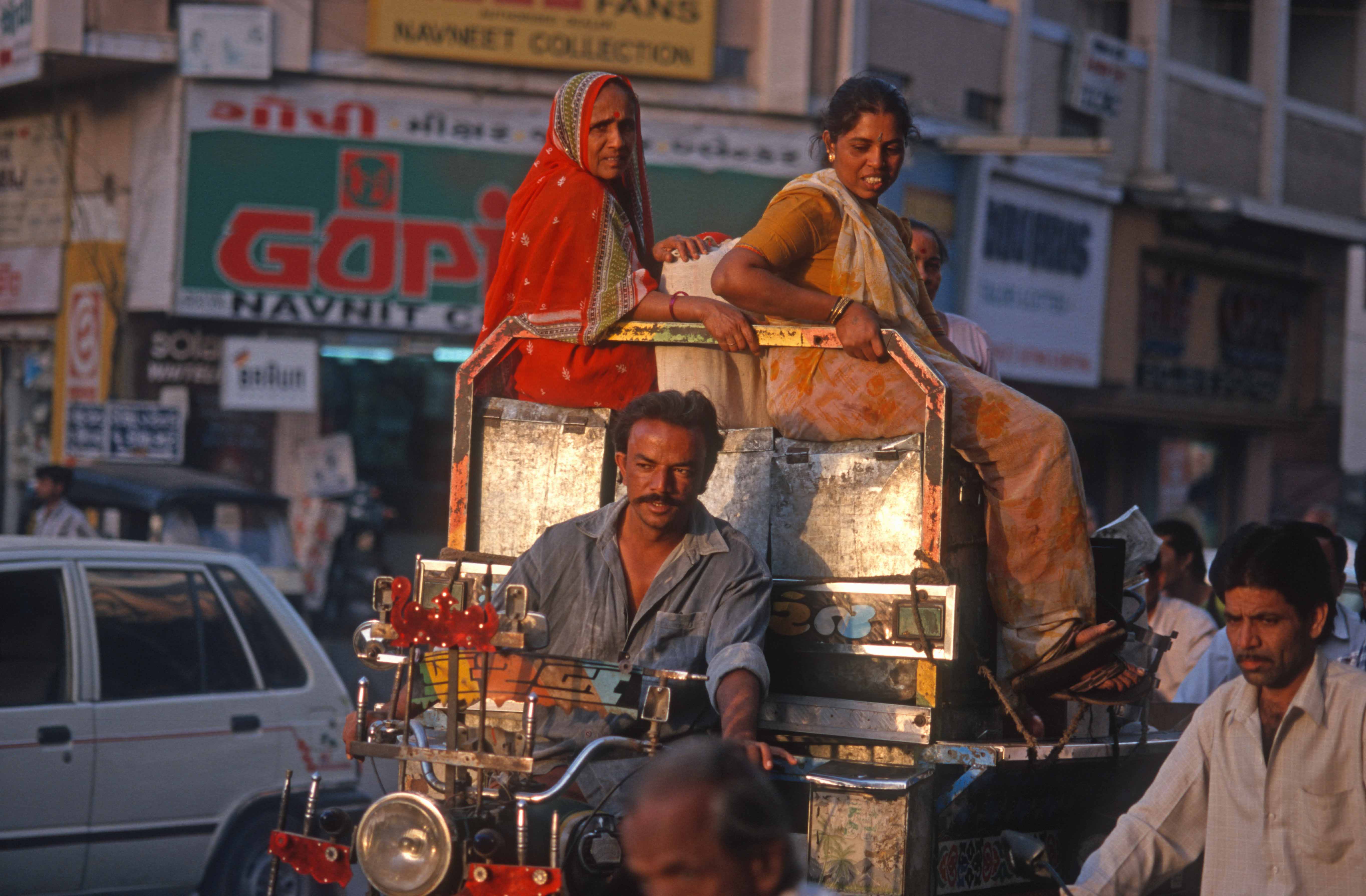 T9638. Women sit atop sacks on a motor rickshaw. Rajkot. Gujarat. India. 11.02.2000crop